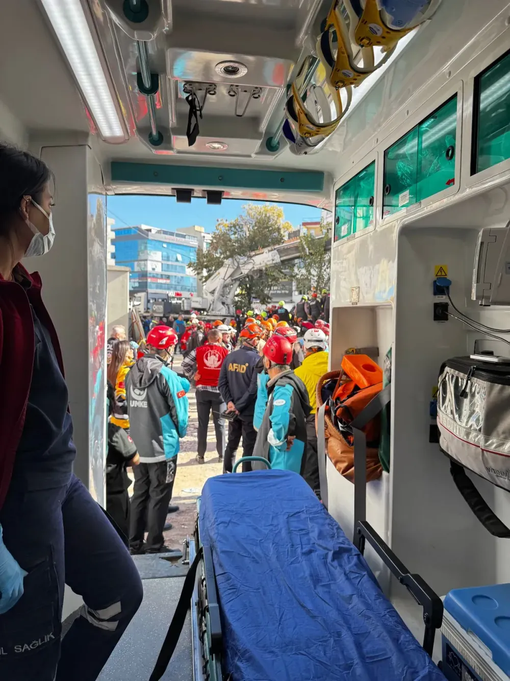 An emergency response team assisting outside an ambulance